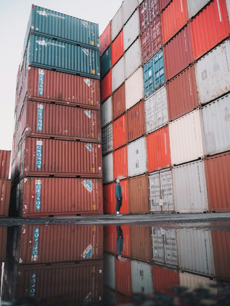 Vivid image of stacked shipping containers at an outdoor industrial location.